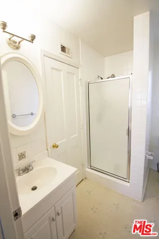 a bathroom with a sink a mirror and a shower