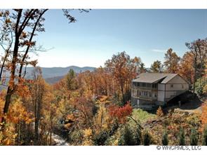 144 Sunny Ridge Road Laurel Park, NC 28739 - Photo 1 of 12 a view of a house with a mountain and a forest