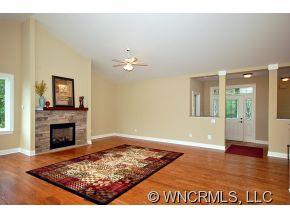 144 Sunny Ridge Road Laurel Park, NC 28739 - Photo 3 of 12 a view of a livingroom with wooden floor and a fireplace