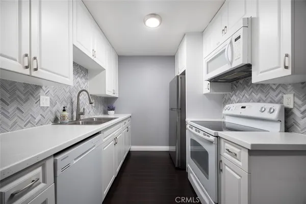 a kitchen with a sink stove and cabinets