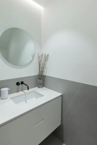 a bathroom with a double vanity sink a large mirror and a shower
