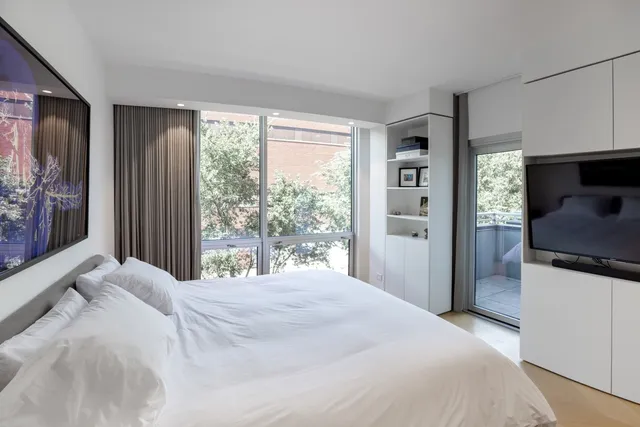 a bedroom with a large bed and a large window