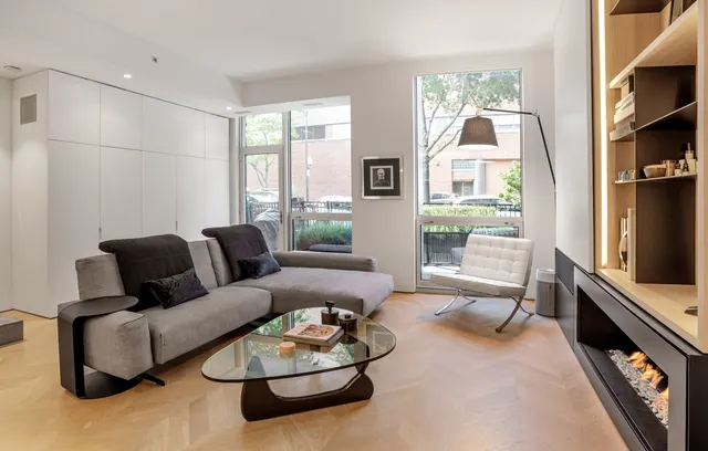 a living room with furniture a rug and a window