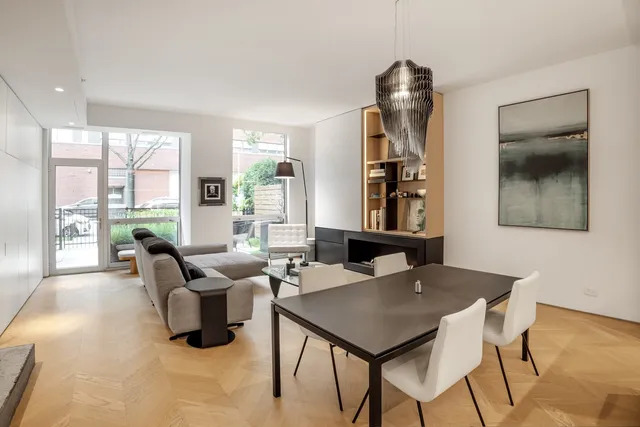 a kitchen with a table chairs sink and cabinets