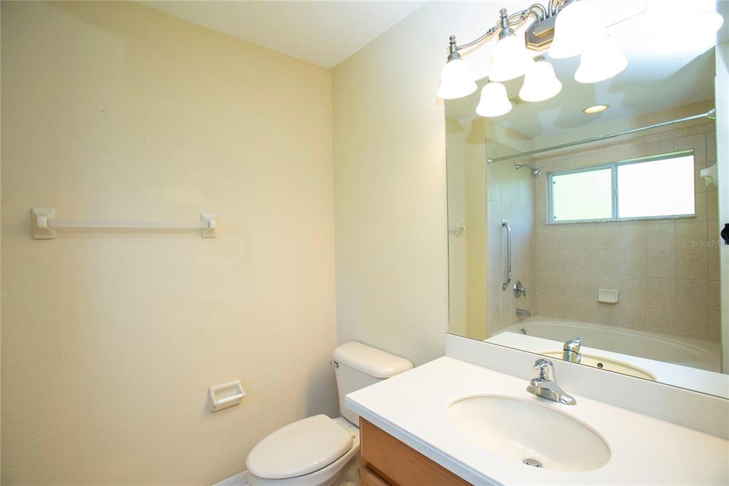 11919 Essington Street New Port Richey, FL 34654 - Photo 13 of 46 a bathroom with a sink mirror vanity and toilet