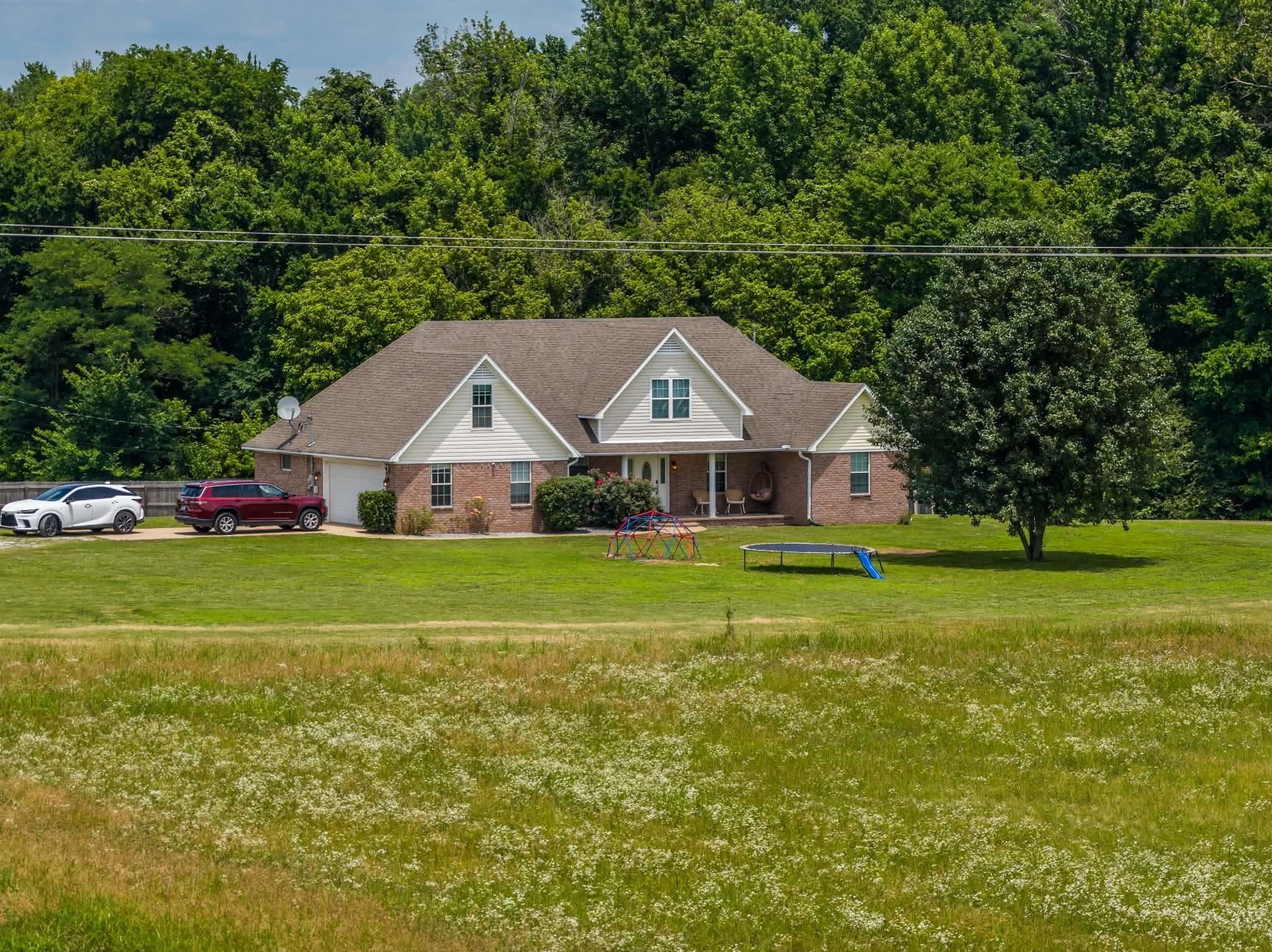 4776 Campground Road Munford, TN 38058 - Photo 1 of 25 a front view of a house with garden
