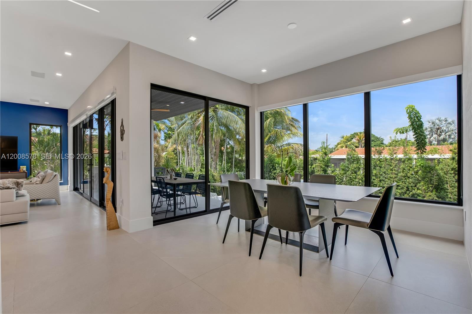 8826 Froude Avenue Surfside, FL 33154 - Photo 19 of 51 a dining room with furniture water view and a floor to ceiling window