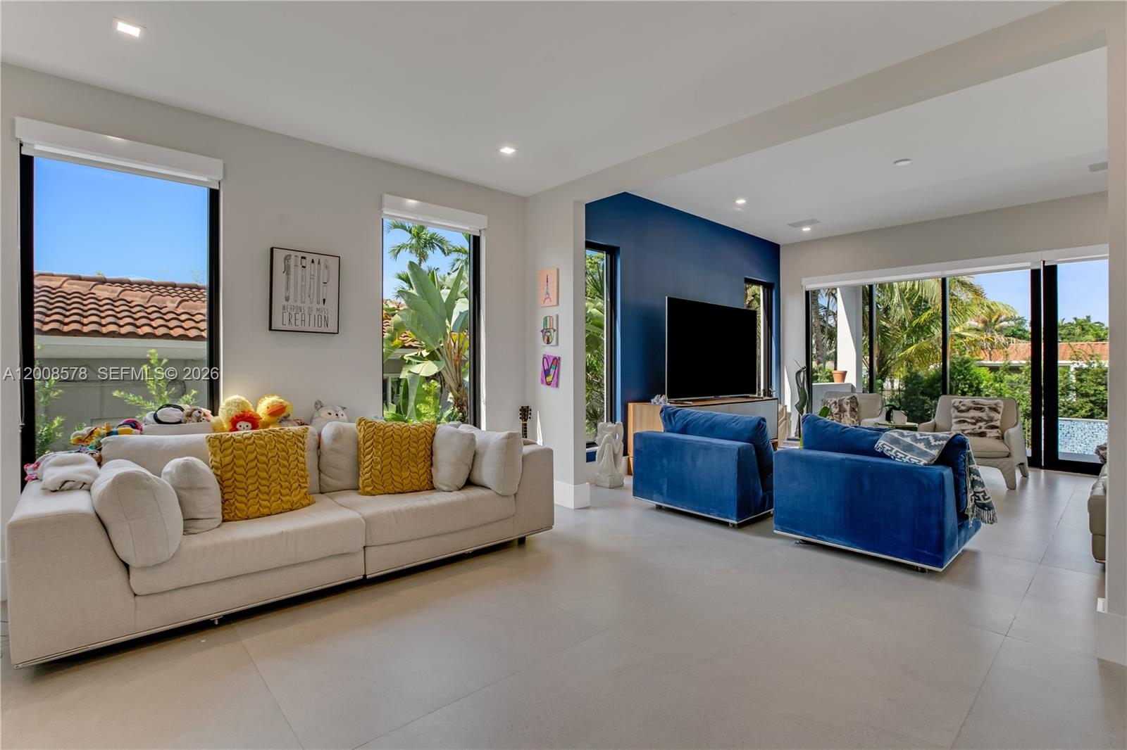 8826 Froude Avenue Surfside, FL 33154 - Photo 24 of 51 a living room with furniture and a flat screen tv