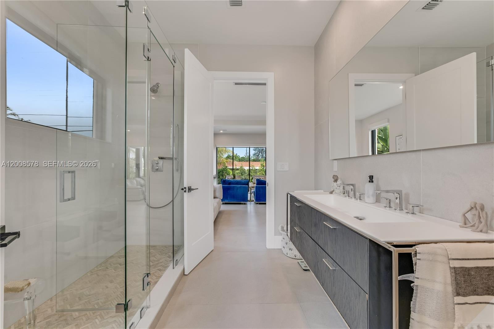 8826 Froude Avenue Surfside, FL 33154 - Photo 28 of 51 a bathroom with a double vanity sink mirror and shower