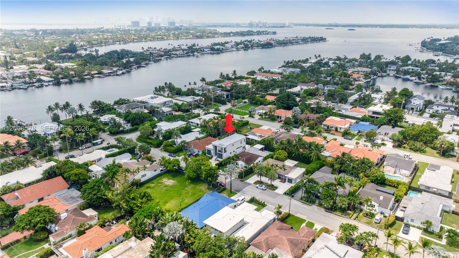 8826 Froude Avenue Surfside, FL 33154 - Photo 49 of 51 an aerial view of city and lake with trees all around