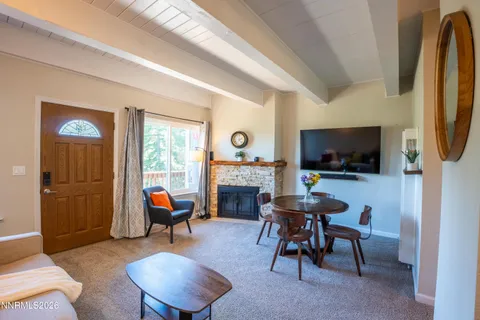 a living room with furniture a flat screen tv and a window