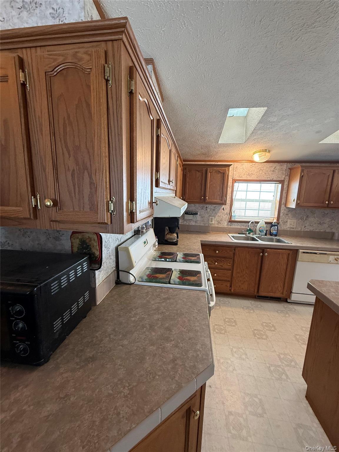 263 Mongaup Road Hurleyville, NY 12747 - Photo 11 of 22 a kitchen with a stove a sink and a microwave