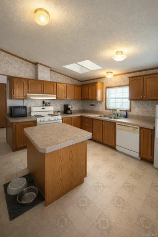 a kitchen with a stove a sink and a refrigerator