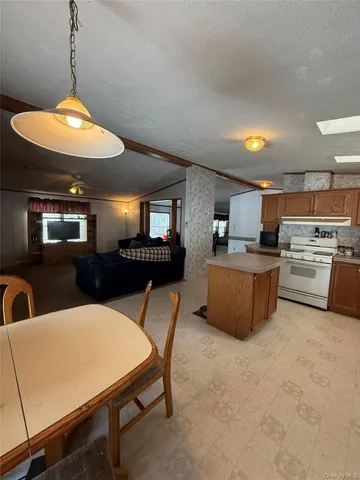 a view of a dining room with furniture and a chandelier