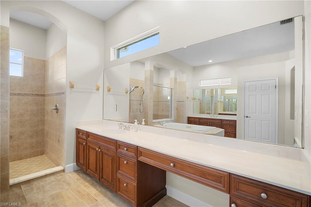 7915 Founders Circle Naples, FL 34104 - Photo 12 of 25 Bathroom with a walk in shower and vanity