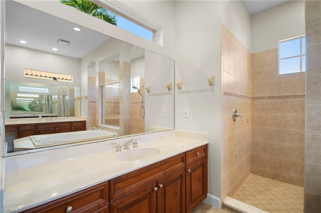 7915 Founders Circle Naples, FL 34104 - Photo 13 of 25 Full bath featuring walk in shower, healthy amount of natural light, and vanity