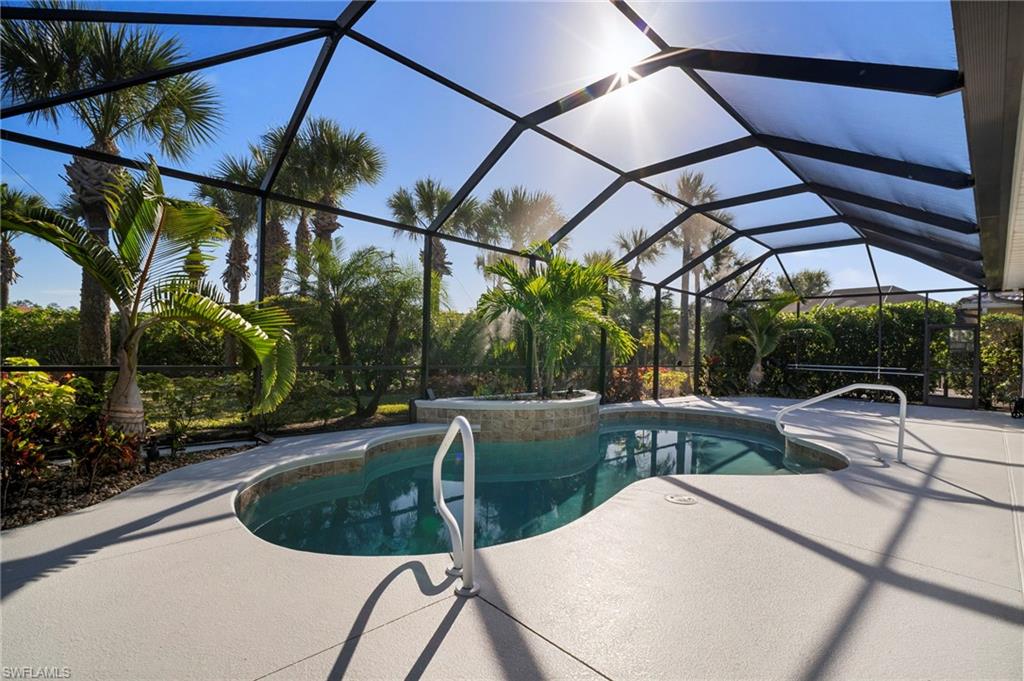 7915 Founders Circle Naples, FL 34104 - Photo 19 of 25 Swimming pool featuring a lanai, a sunroom, and a patio