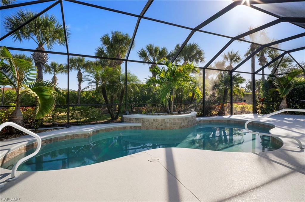 7915 Founders Circle Naples, FL 34104 - Photo 20 of 25 Outdoor pool with a lanai, a patio area, and a sunroom