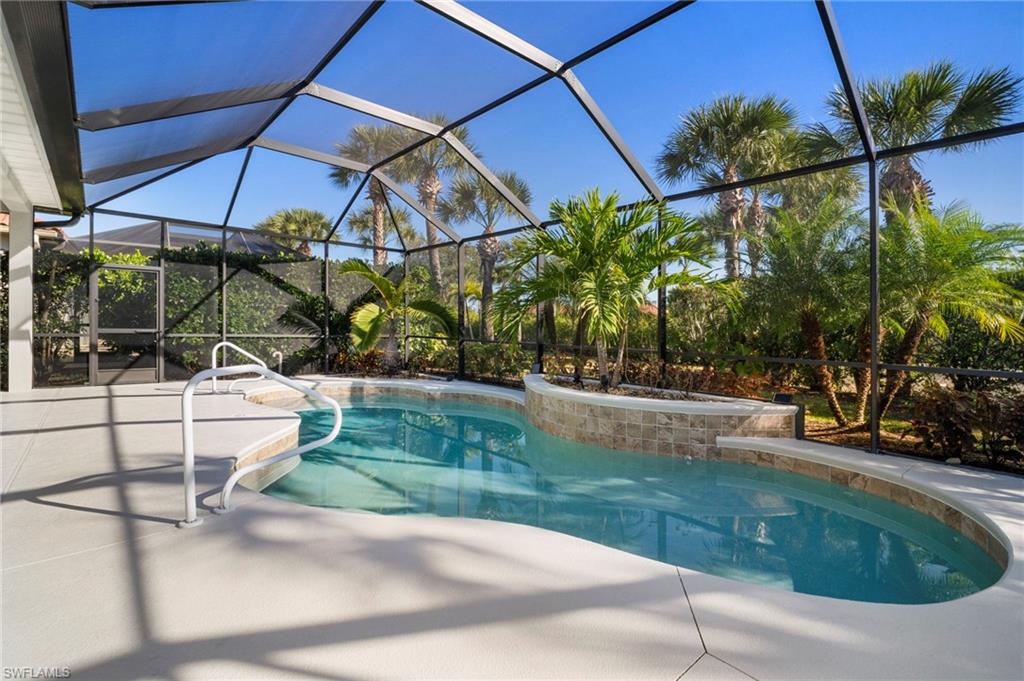 7915 Founders Circle Naples, FL 34104 - Photo 21 of 25 Swimming pool with a sunroom, glass enclosure, and a patio