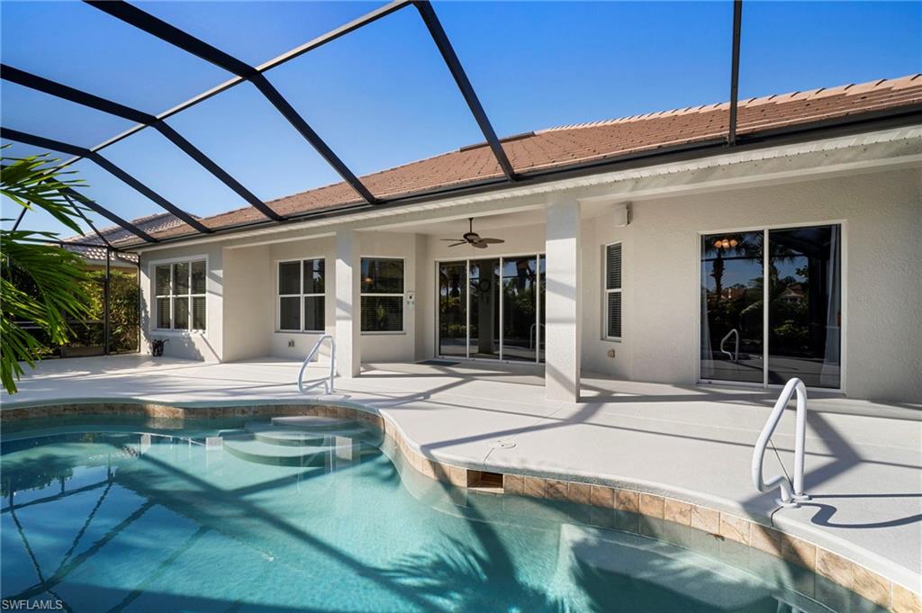 7915 Founders Circle Naples, FL 34104 - Photo 22 of 25 Outdoor pool with glass enclosure, a patio, and a sunroom