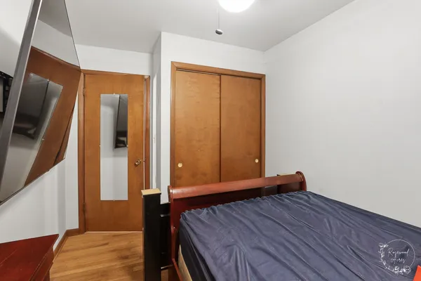 a view of a room with wooden floor and bedroom