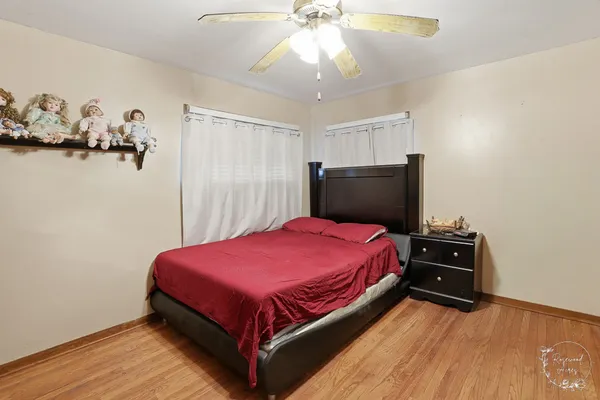 a bed room with a bed and a ceiling fan
