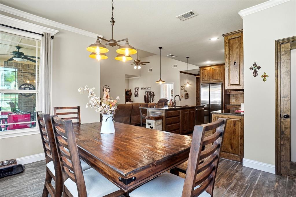 1024 Tex Lane Springtown, TX 76082 - Photo 17 of 40 a dining room filled chandelier and wooden floor