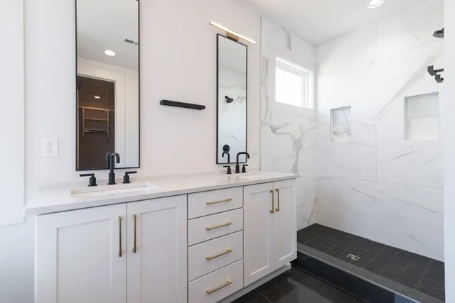 a bathroom with a double vanity sink and mirror