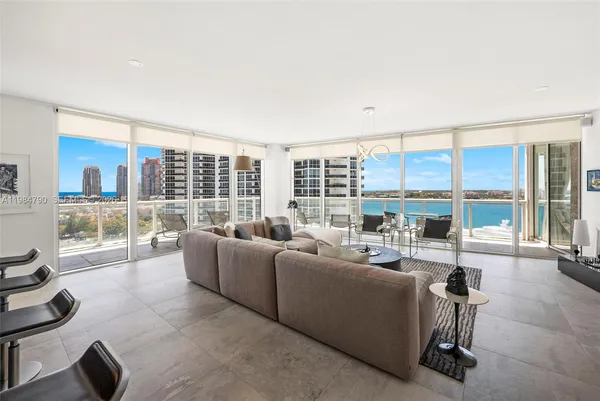 a living room with furniture and a painting on the wall
