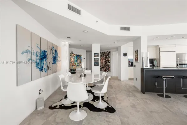 a kitchen with stainless steel appliances kitchen island granite countertop a refrigerator and a sink