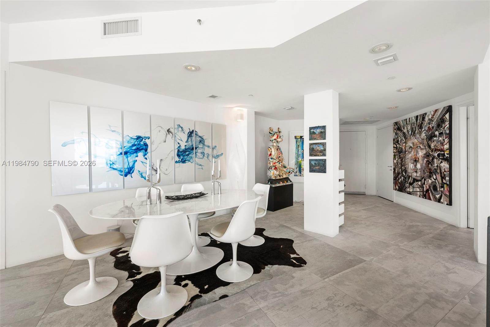 450 Alton Road, Unit 1507 Miami Beach, FL 33139 - Photo 18 of 72 a living room with furniture and a painting on the wall