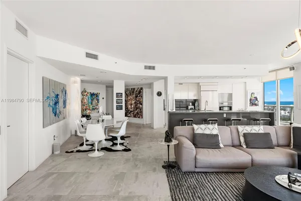 a large kitchen with kitchen island a large window in it
