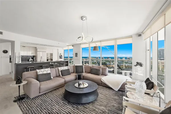 a living room with furniture and a large window