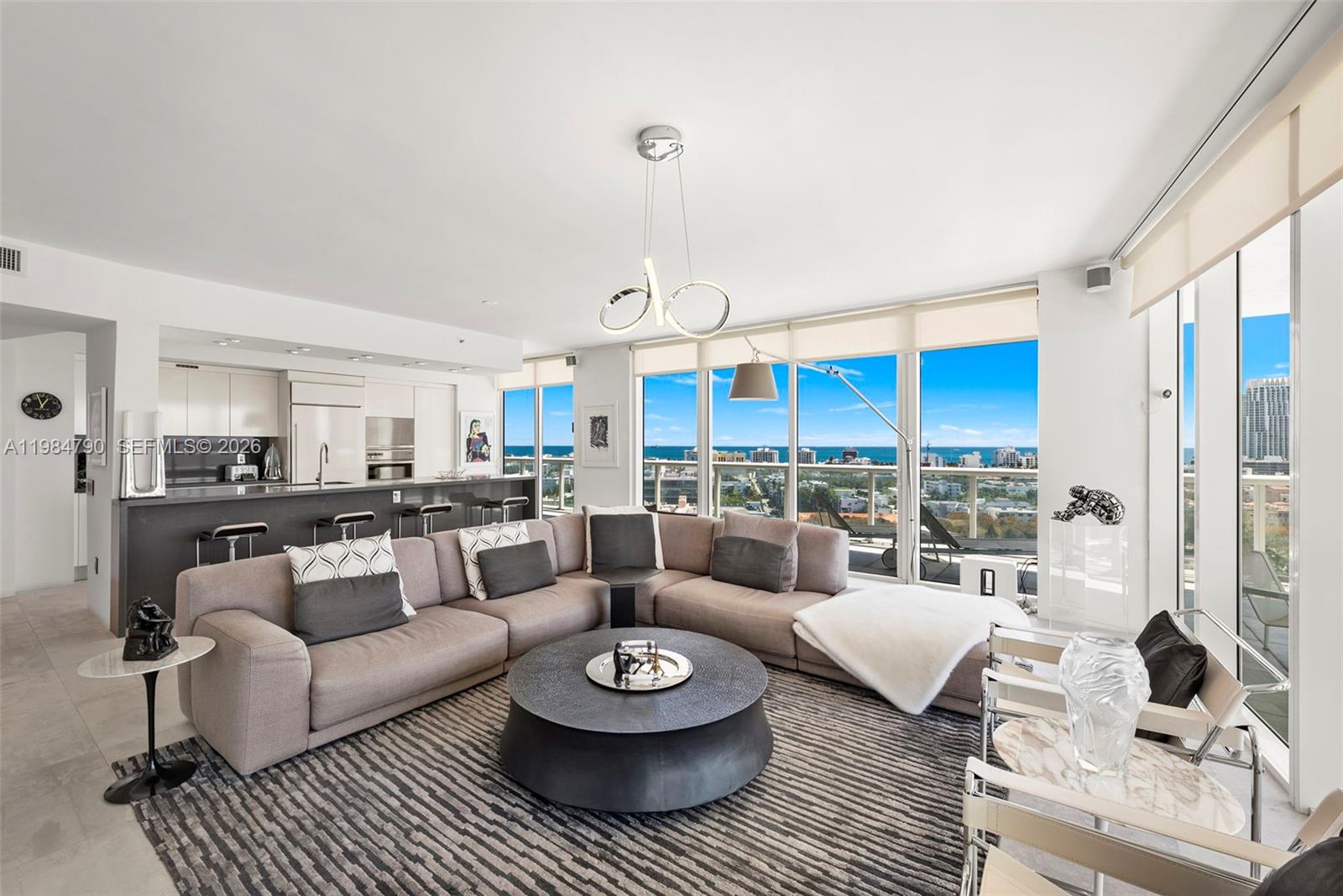 450 Alton Road, Unit 1507 Miami Beach, FL 33139 - Photo 2 of 72 a living room with furniture and a large window