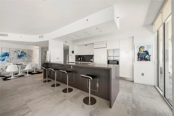 a spacious bedroom with a bed and a large window