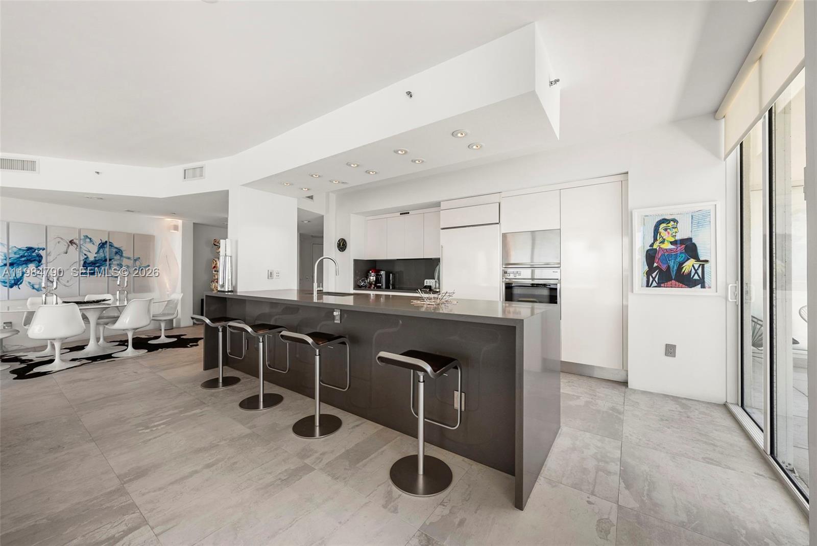 450 Alton Road, Unit 1507 Miami Beach, FL 33139 - Photo 21 of 72 a kitchen with stainless steel appliances kitchen island granite countertop a refrigerator and a sink