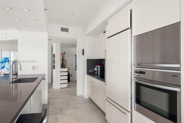 a bedroom with a large bed and a flat tv screen