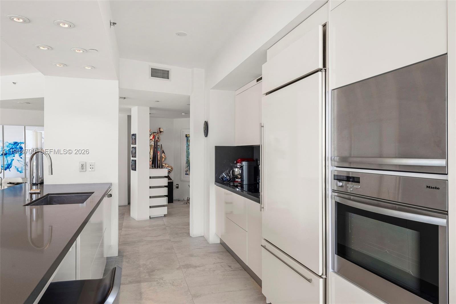 450 Alton Road, Unit 1507 Miami Beach, FL 33139 - Photo 22 of 72 a kitchen with stainless steel appliances granite countertop a refrigerator and a sink