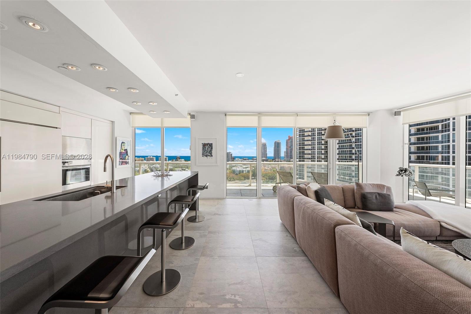 450 Alton Road, Unit 1507 Miami Beach, FL 33139 - Photo 25 of 72 a living room with stainless steel appliances furniture and a kitchen