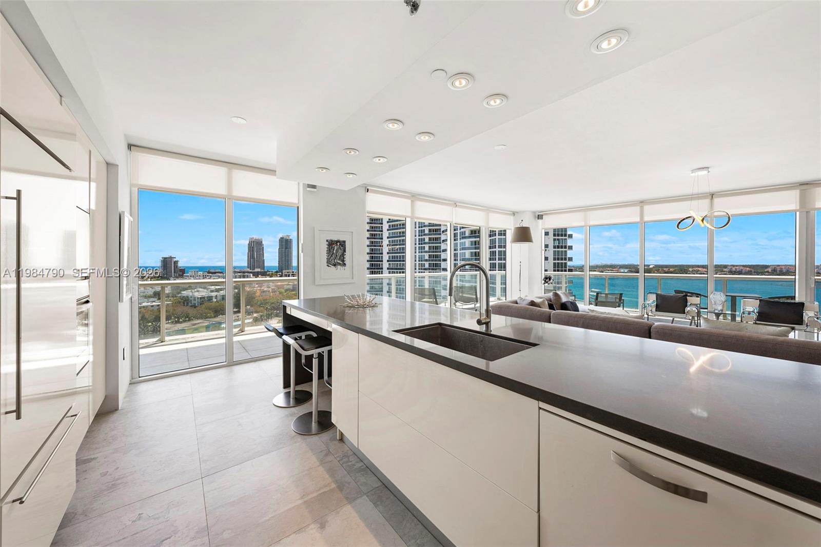 450 Alton Road, Unit 1507 Miami Beach, FL 33139 - Photo 26 of 72 a large kitchen with kitchen island a large window in it