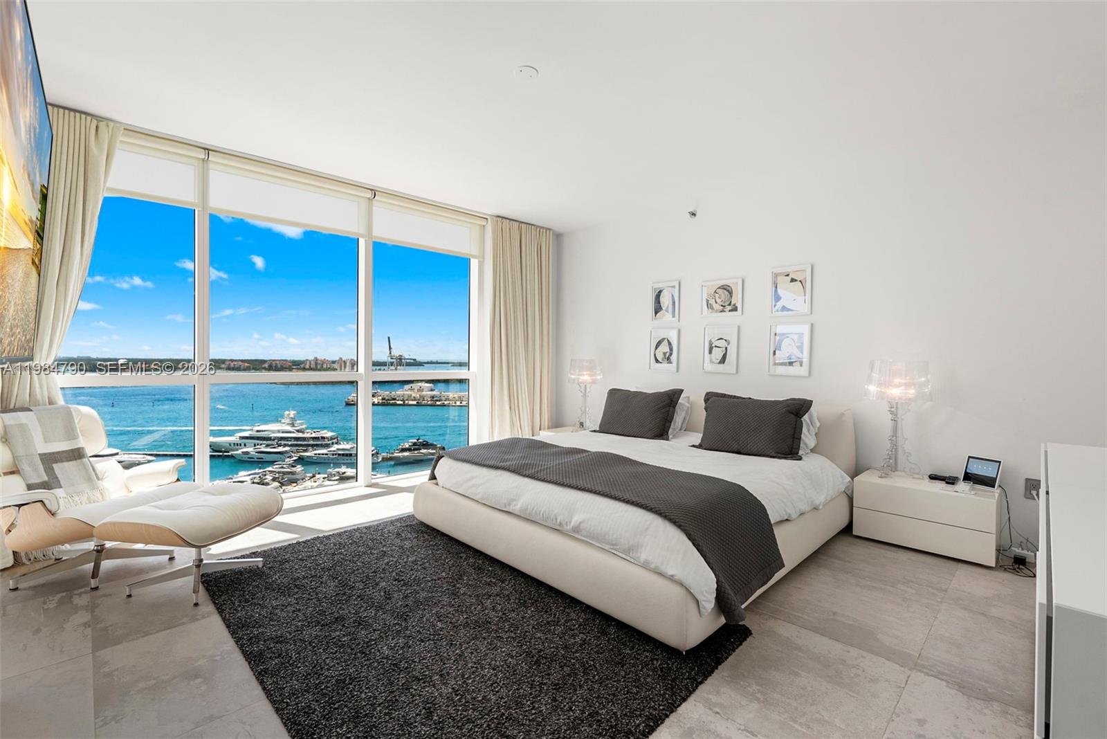 450 Alton Road, Unit 1507 Miami Beach, FL 33139 - Photo 29 of 72 a spacious bedroom with a bed and a large window