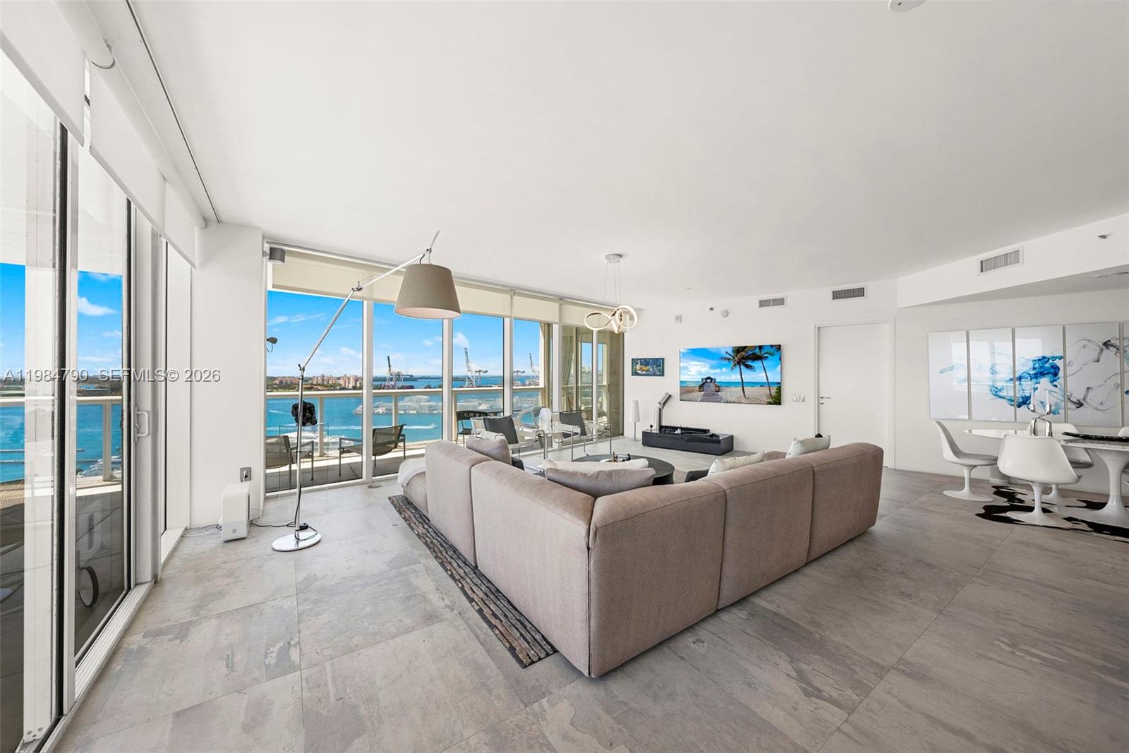 450 Alton Road, Unit 1507 Miami Beach, FL 33139 - Photo 3 of 72 a living room with furniture and a large window
