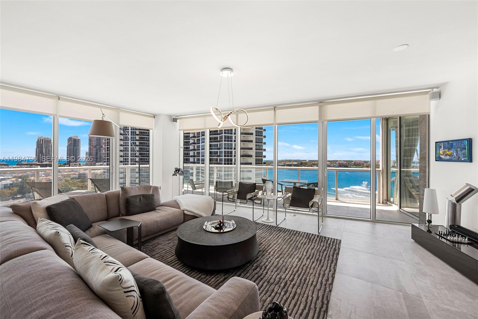 450 Alton Road, Unit 1507 Miami Beach, FL 33139 - Photo 8 of 72 a living room with furniture and a large window