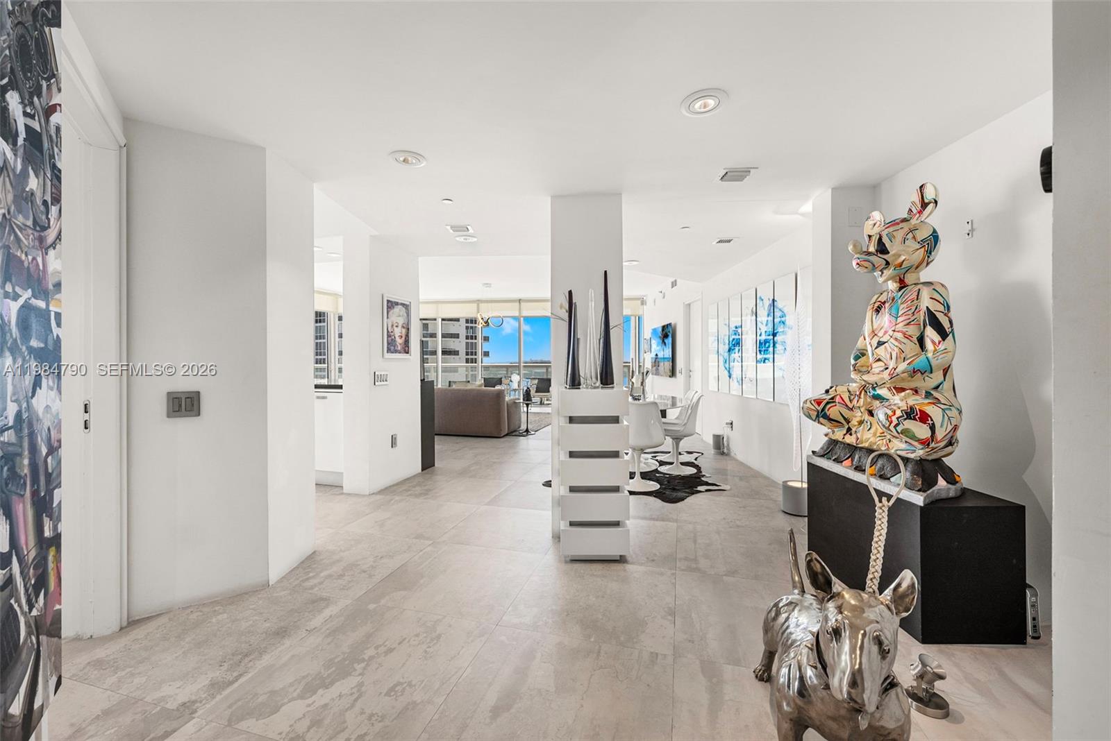 450 Alton Road, Unit 1507 Miami Beach, FL 33139 - Photo 10 of 72 a living room with furniture a rug and white walls