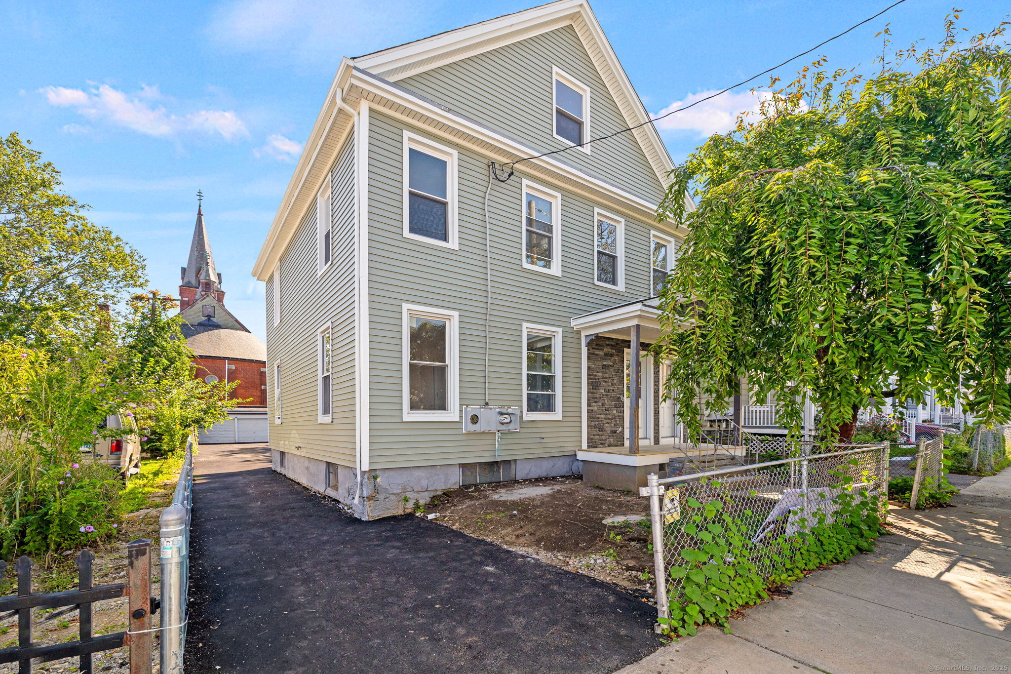 530 Jane Street, Unit 1 Bridgeport, CT 06608 - Photo 3 of 10 a front view of a house with a yard
