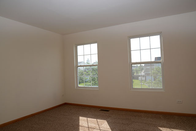 25148 Spring Street Manhattan, IL 60442 - Photo 2 of 15 an empty room with a window