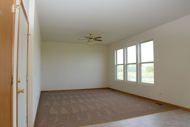 25148 Spring Street Manhattan, IL 60442 - Photo 4 of 15 an empty room with a window