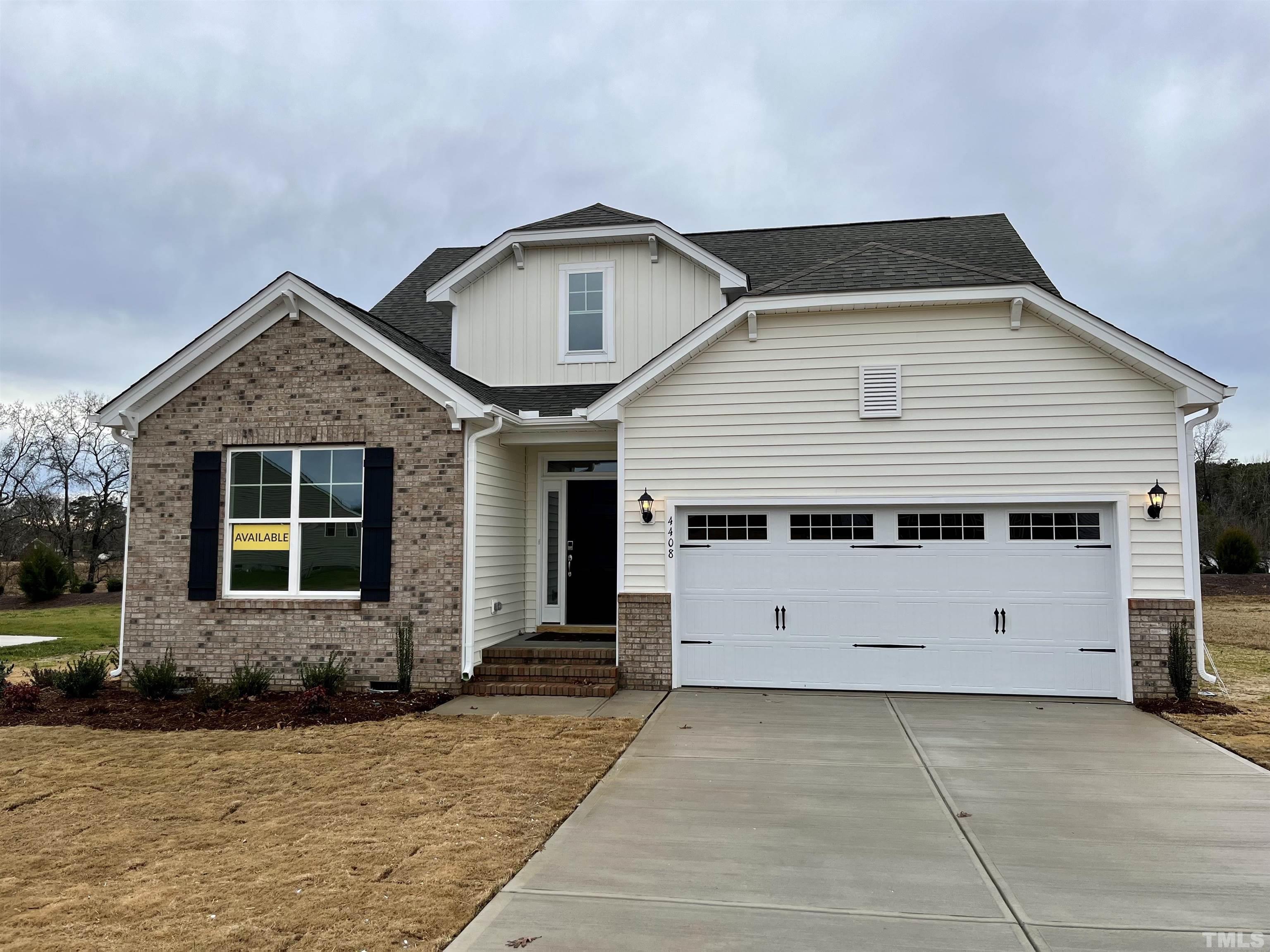 4408 Beckel Road Willow Spring, NC 27592 - Photo 1 of 24 a front view of a house with a garage