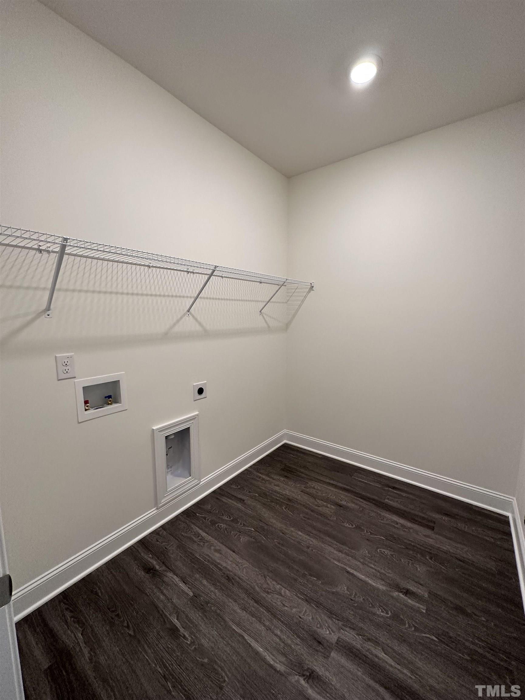 4408 Beckel Road Willow Spring, NC 27592 - Photo 23 of 24 a view of a room with wooden floor and white walls
