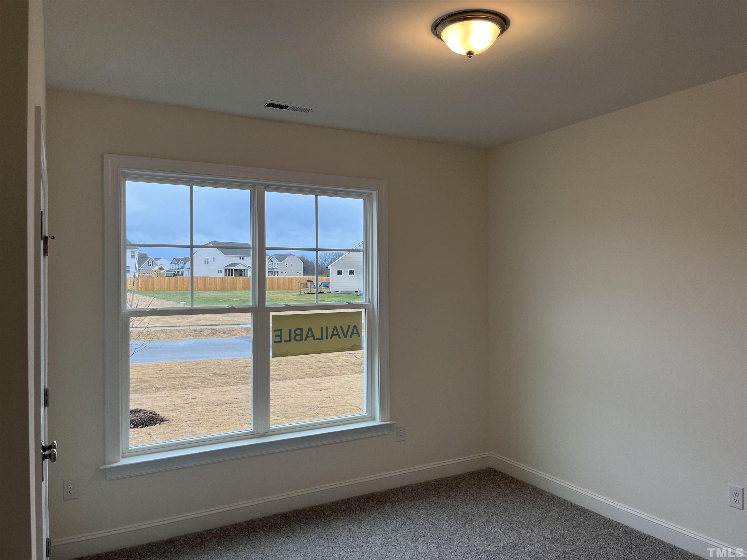 4408 Beckel Road Willow Spring, NC 27592 - Photo 4 of 24 an empty room with a window